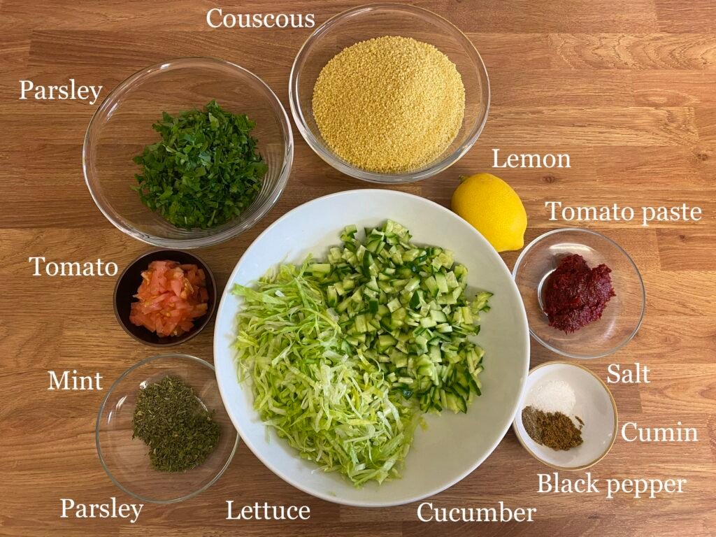 Ingredients for recipe: couscous, parsley, tomato, mint, lettuce, cucumber, black pepper, salt, cumin, tomato paste and lemon.