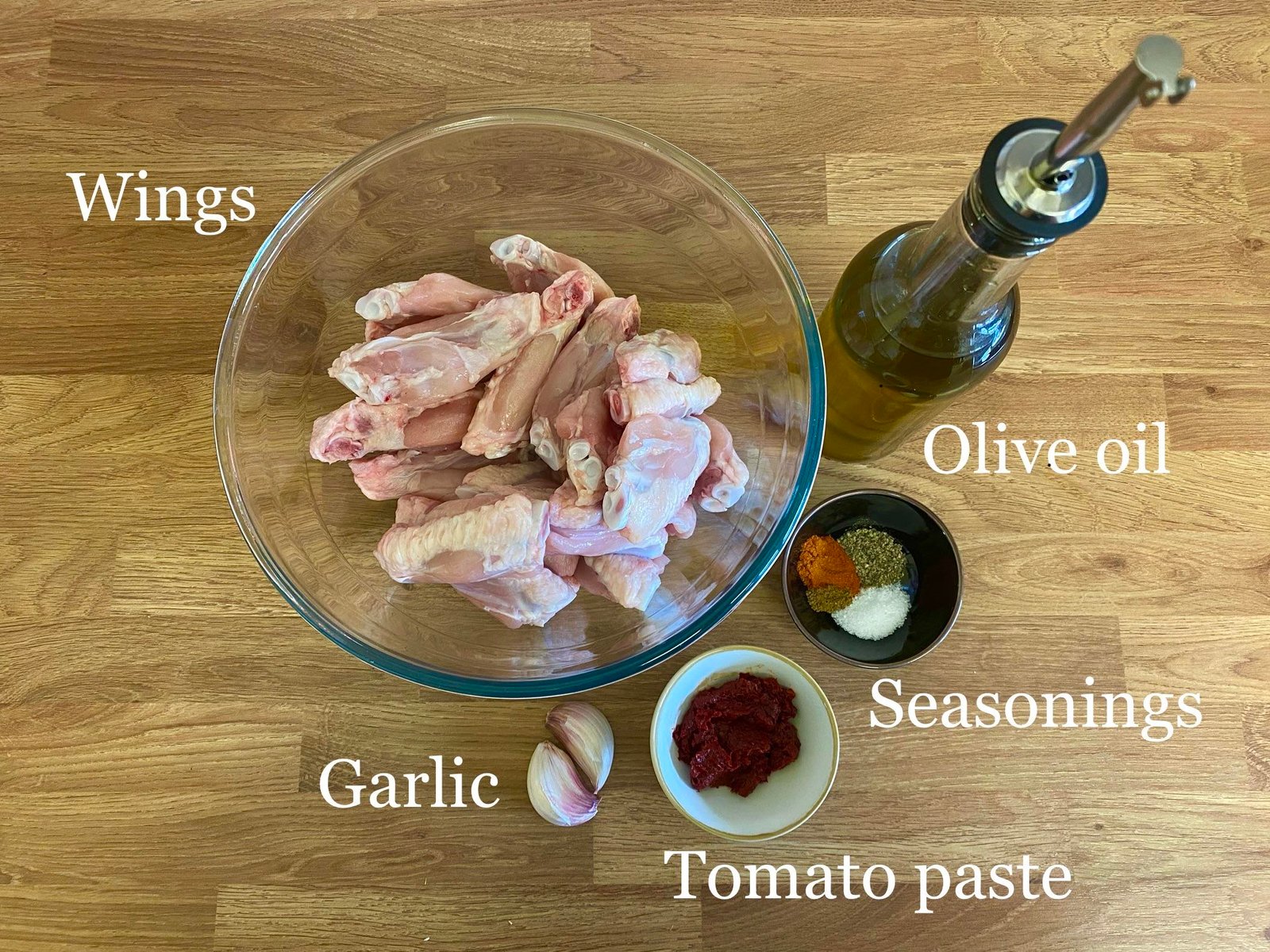 Ingredients for recipe: chicken wings, olive oil, garlic, seasonings and tomato paste