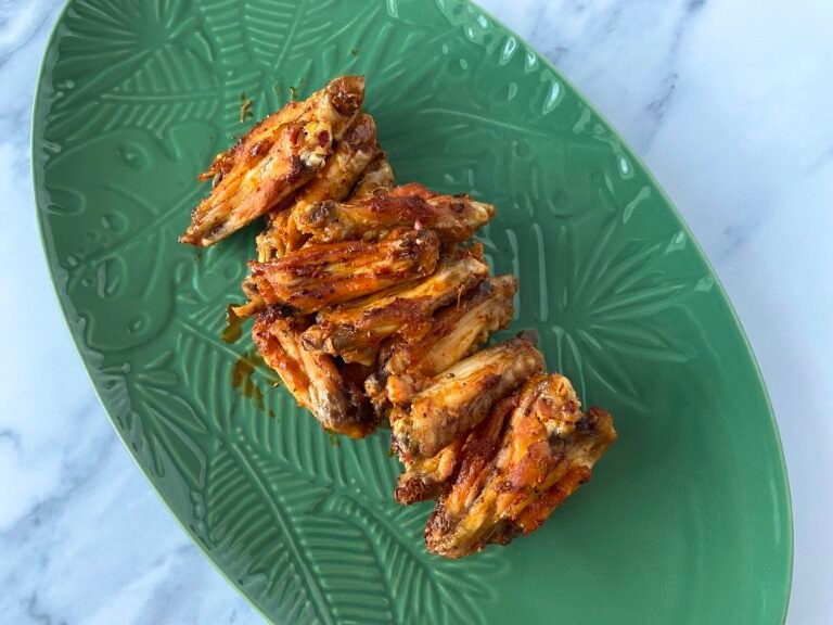 Plate of juicy chicken wings on a serving platter