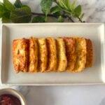Perfect fried halloumi slices on a platter, served with sweet chilli tomato jam Nandos' dip and fresh mint leaves