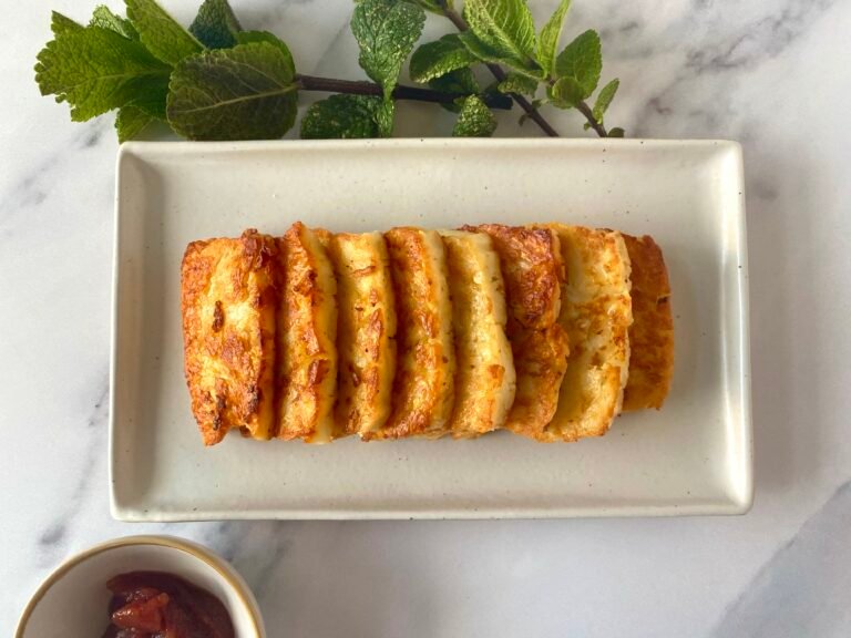 Perfect fried halloumi slices on a platter, served with sweet chilli tomato jam Nandos' dip and fresh mint leaves