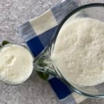A cool glass and jug of ayran, or yoghurt drink, served with fresh mint leaves
