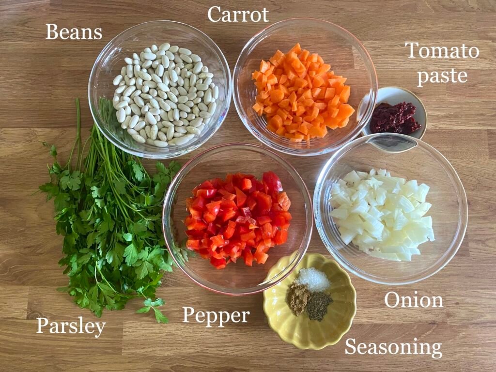 Ingredients for recipe: white cannellini beans, carrot, tomato paste, onion, seasonings, pepper and parsley