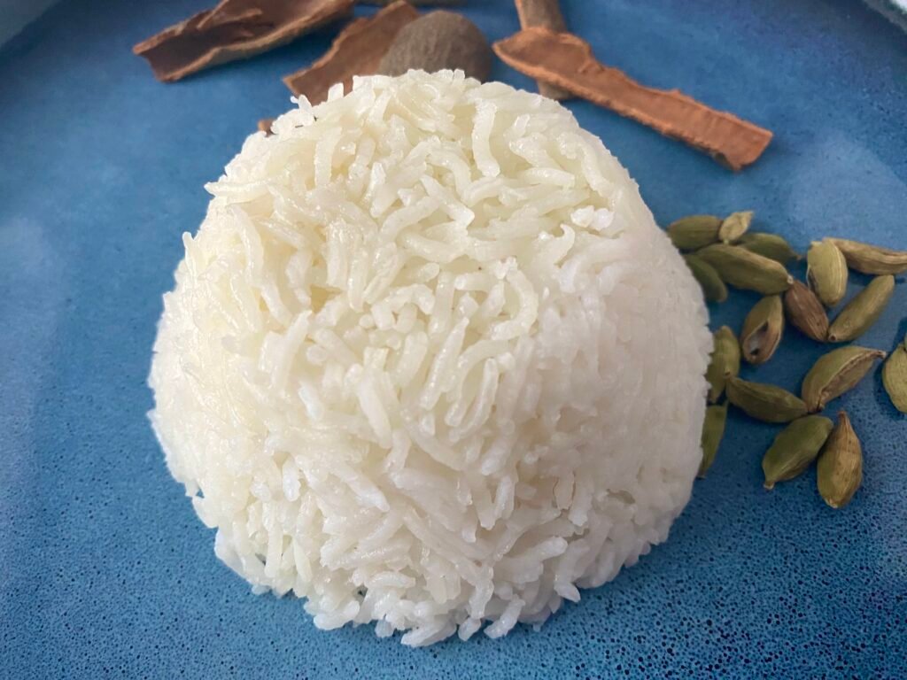 Serving of basmati rice with cinnamon and cardamom pods