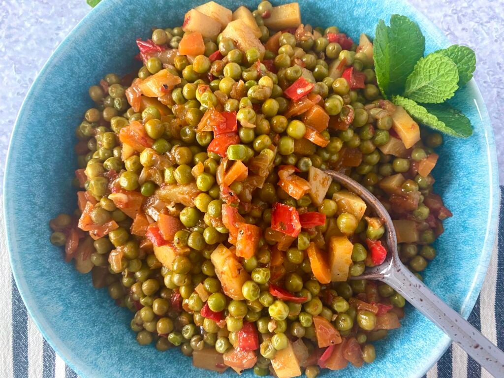 Serving of hearty pea and potato stew with some fresh mint leaves