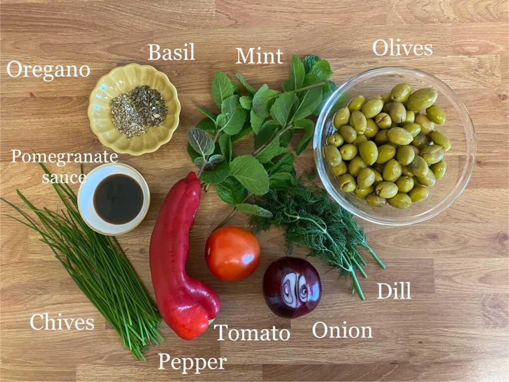 Ingredients for recipe: olives, dill, onion, tomato, pepper, chives, pomegranate sauce, oregano, basil and mint