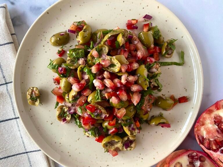 Olive and herb salad served with pomegranate seeds