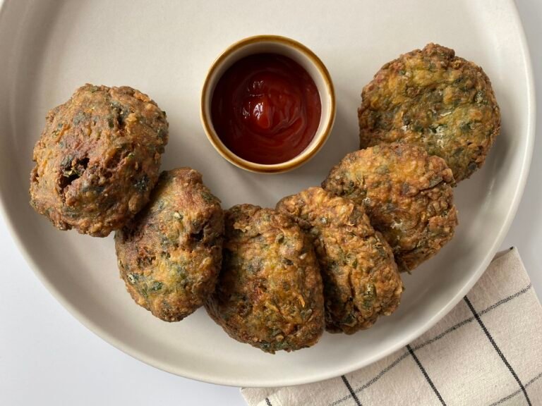 Zucchini fritters on a plate served with ketchup