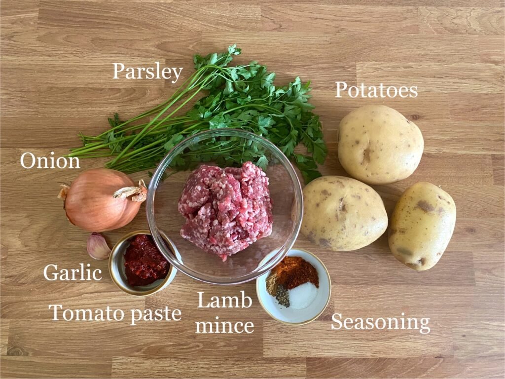 Ingredients for recipe: parsley, lamb mince, onion, garlic, tomato paste, seasonings and potatoes