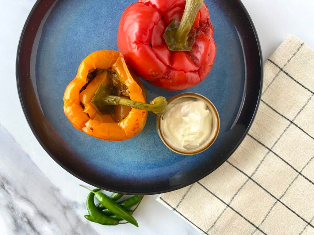 Rice stuffed peppers served with yoghurt