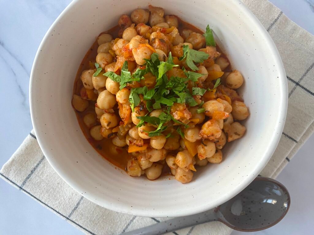 Chickpeas and carrot stew with flat leaf parsley sprinkled on top