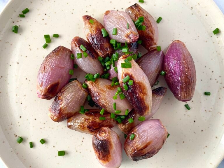 Air fryer shallots with chives sprinkled on top.