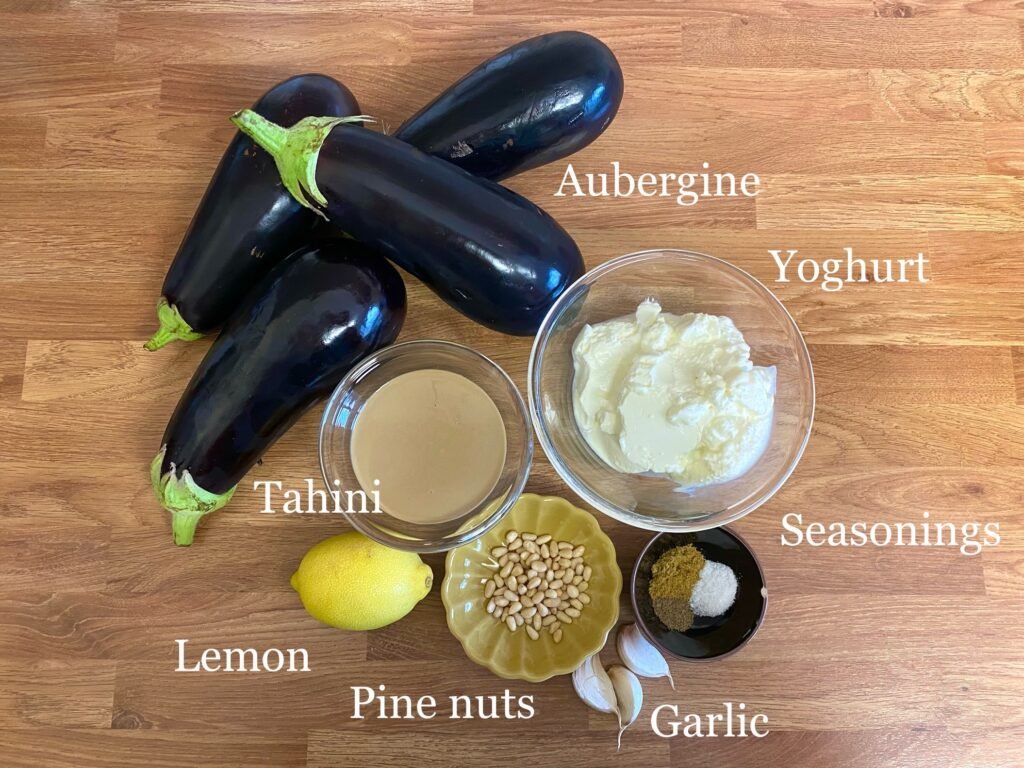 Ingredients for recipe: aubergine (eggplant), tahini, yoghurt, lemon, garlic, seasonings and pine nuts.