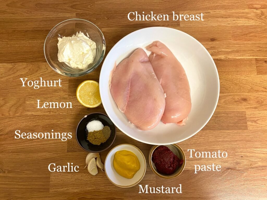 Ingredients for recipe: chicken breast fillets, yoghurt, garlic, lemon, seasonings, mustard and sun-dried tomato paste.