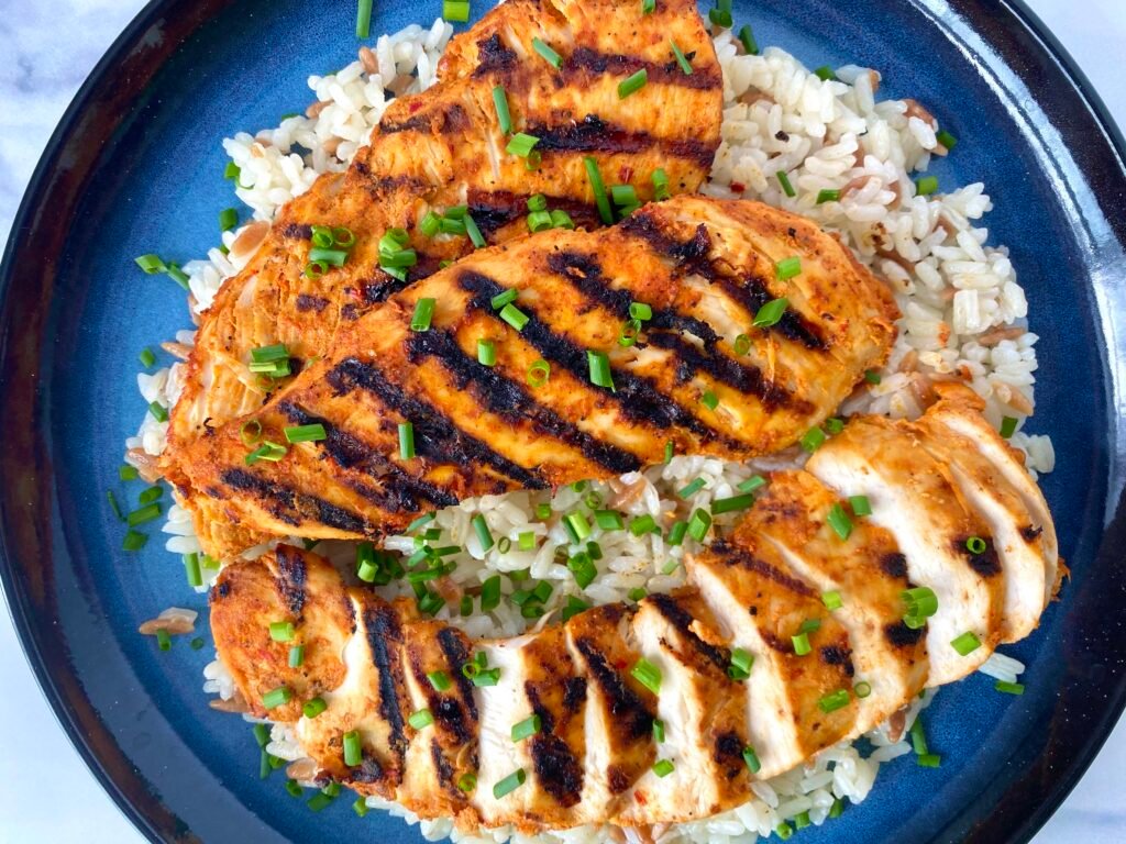 Kebab-style grilled chicken breast fillets with rice and chives.