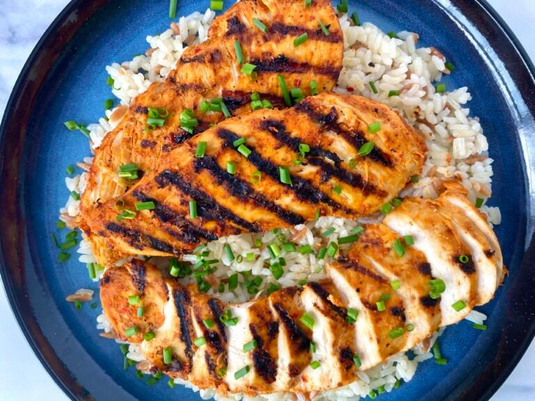 Kebab-style grilled chicken breast fillets with rice and chives.