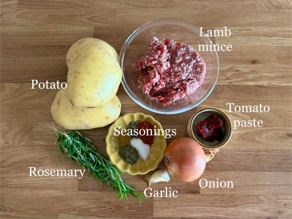 Shepherd's Pie ingredients: lamb mince, potatoes, rosemary, seasonings, garlic, onion and sun-dried tomato paste.