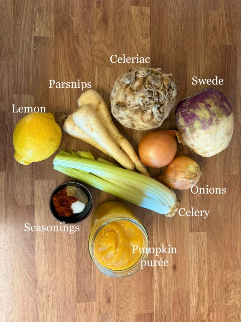 Fresh ingredients for Rose's Harvest Soup arranged on a kitchen countertop: chopped swede, celeriac, parsnips, leek, pumpkin purée, celery, and onions, alongside spices like paprika, cumin, and red pepper flakes. These seasonal root vegetables and aromatic spices create a hearty, nutrient-rich autumn soup ideal for meal prep and fall dinners.