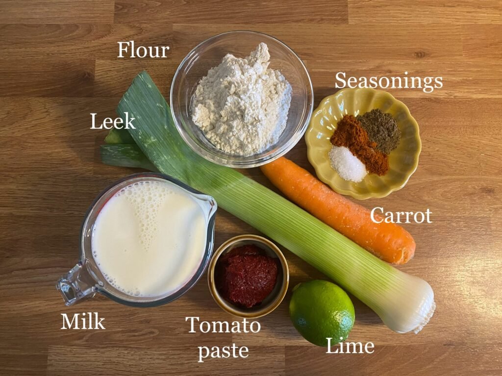 Creamy leek bechamel soup ingredients: flour, milk, olive oil, tomato paste, leeks, carrots, seasonings.