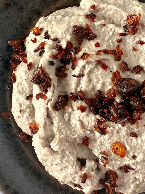 White cannellini bean hummus with crispy onions sprinkled on top